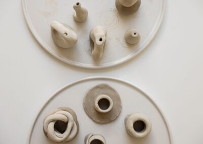 Artistic display of handmade clay pottery showcasing creative designs and craftsmanship.