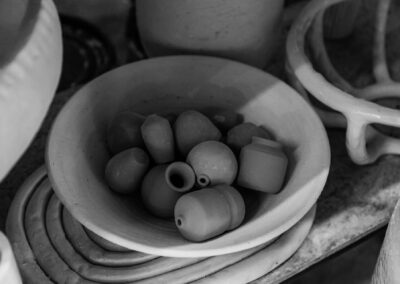 Black and white image of ceramic bowls and pots in artistic arrangement.